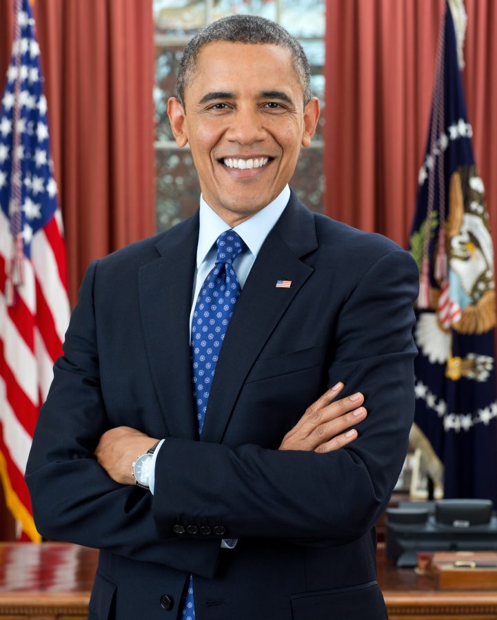 President Barack Obama, the first Black and Biracial President of the United States, smiling for the camera.