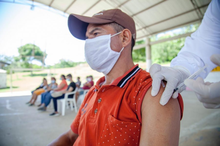 a man getting a booster shot for the Covid 19 vaccine